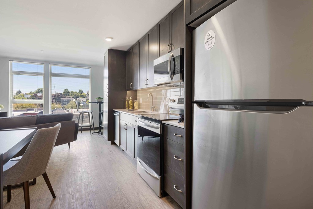 kitchens equipped with stainless steel appliances and dark cabinets