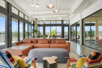 a living room filled with furniture and a large window