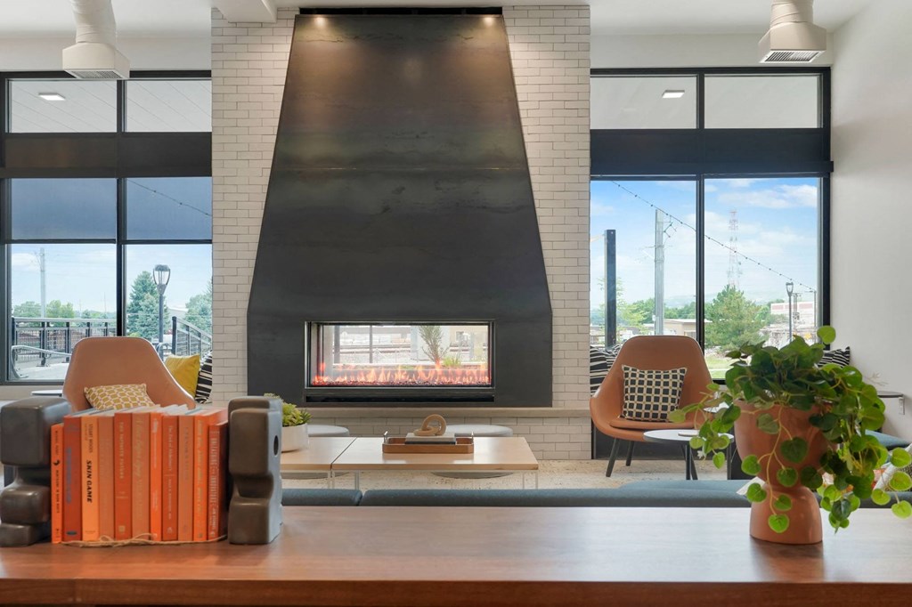 a living room with a fireplace and a large window