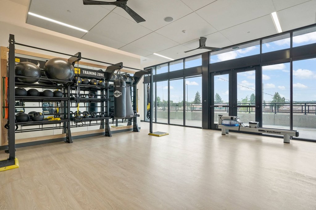 a large room with glass windows and a large metal structure with weights and other equipment in it