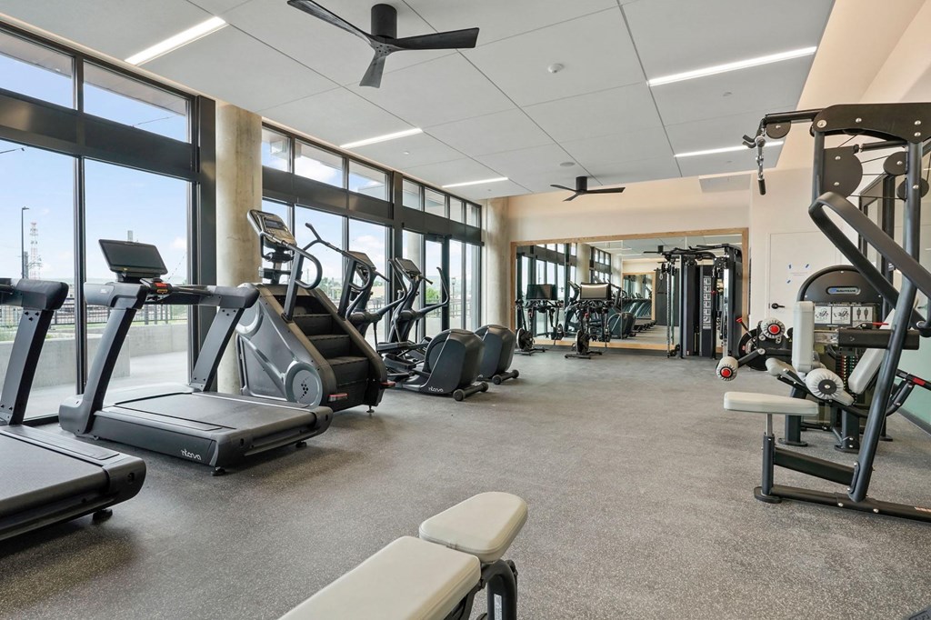 Studios In Wheat Ridge, CO - The Parallel - Fitness Center Equipped With Cardio Machines, Strength Training Machines, Full Body Mirror, And Floor To Ceiling Windows