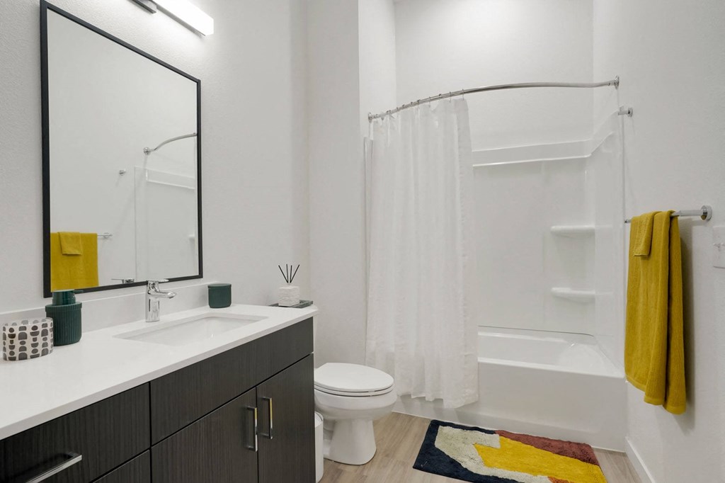 a bathroom with a sink toilet and shower
