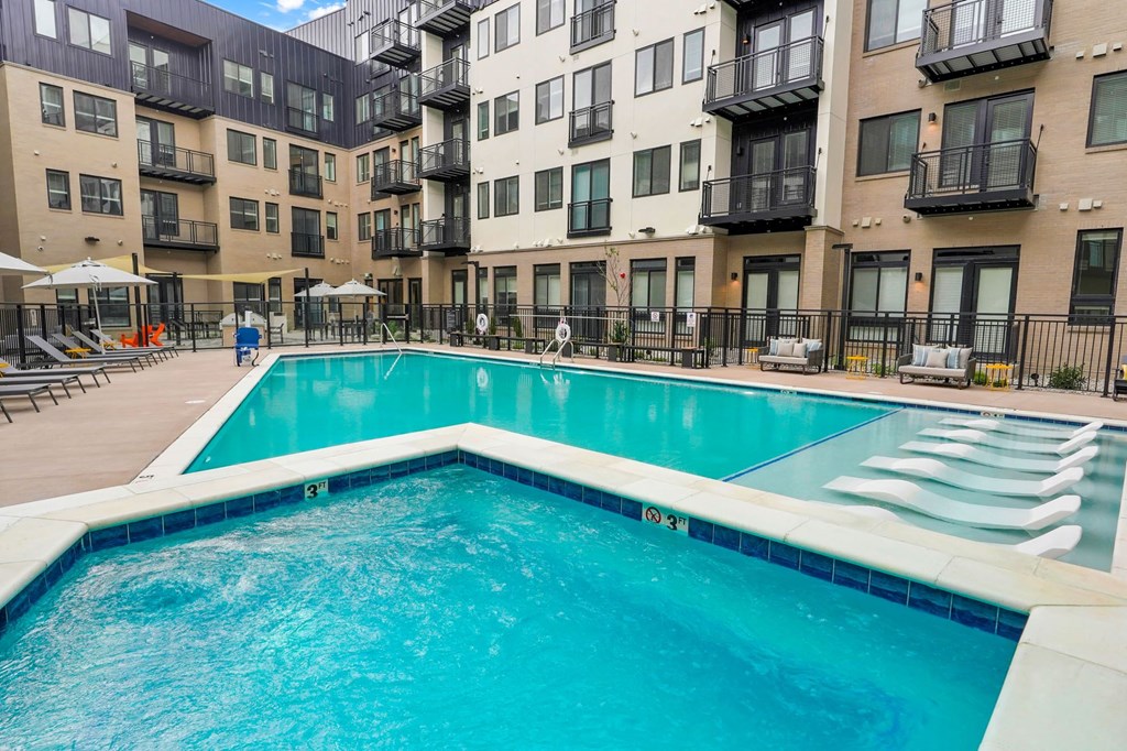 a swimming pool in front of an apartment building