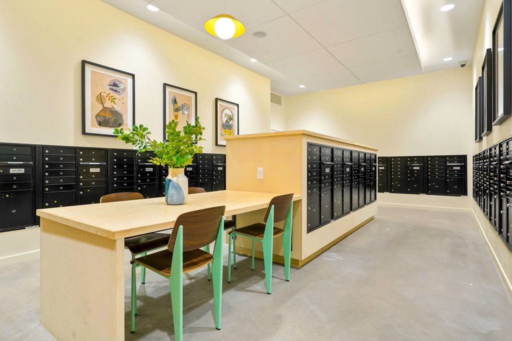 a room with a table and chairs in front of a row of lockers