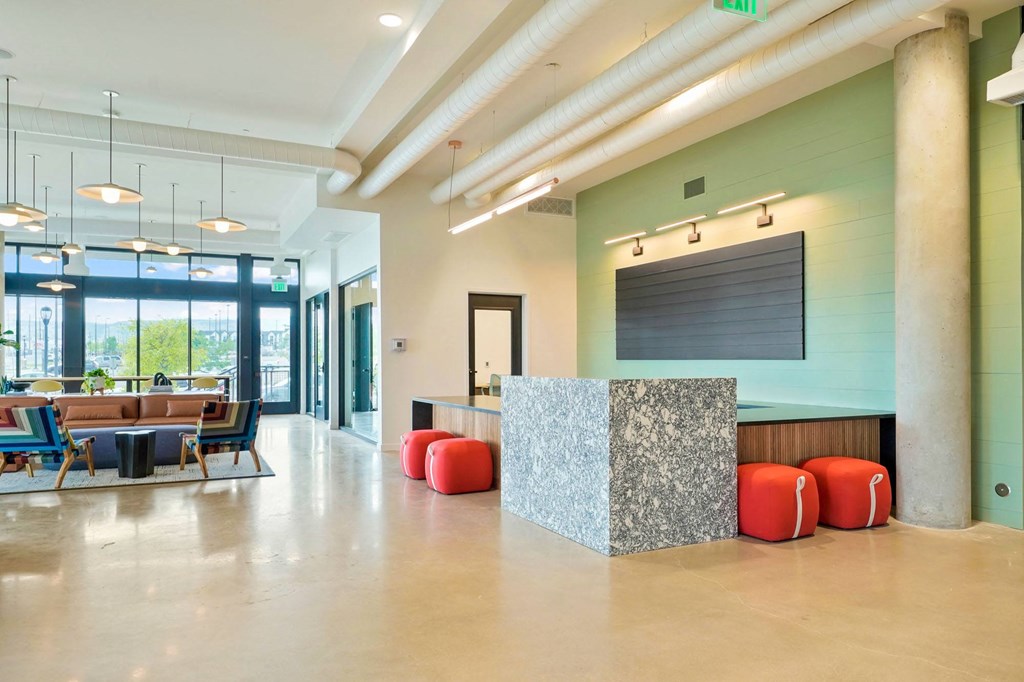 a reception area with a desk and chairs and a large window