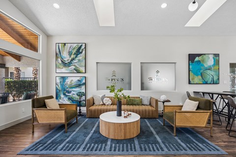 A living room with a blue rug and a wooden coffee table.
