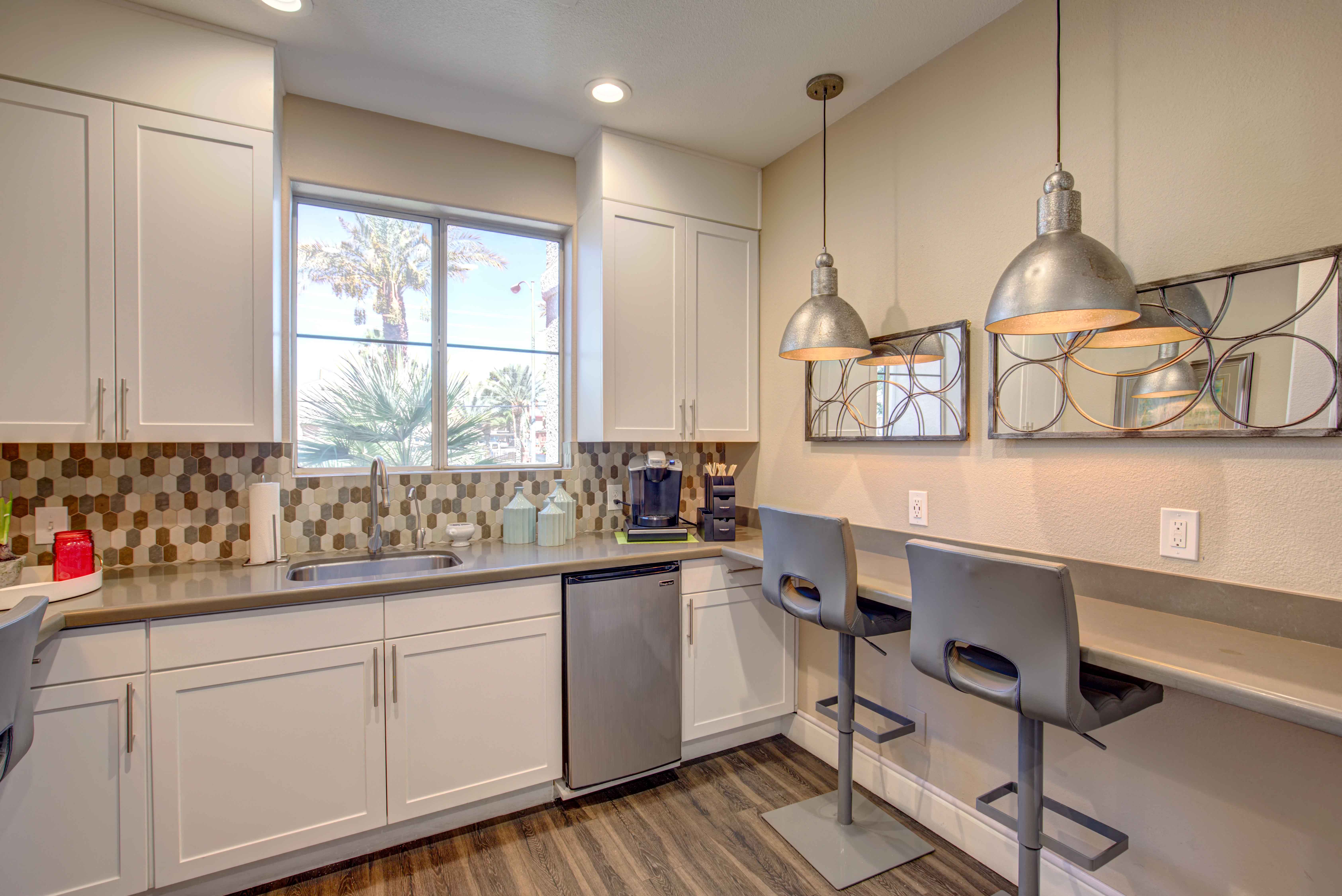 a kitchen with white cabinets and a counter top