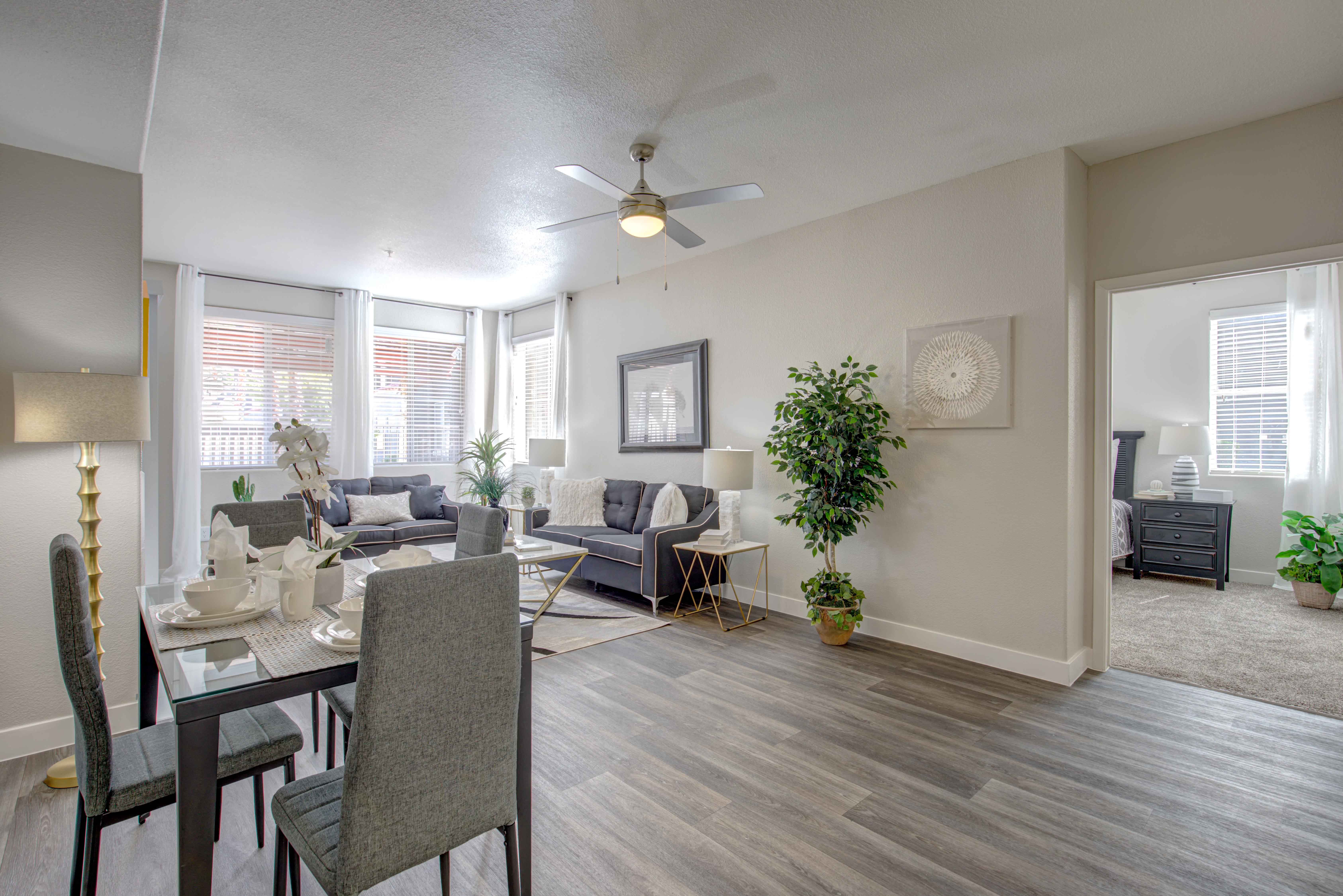 an open living room and dining room with a ceiling fan
