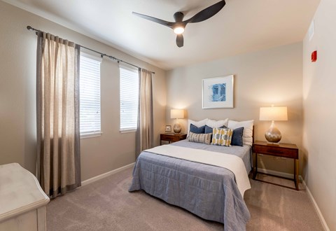 Cozy bedroom featuring a ceiling fan and large windows at The Sanctuary at 331 in Santa Rosa Beach, FL