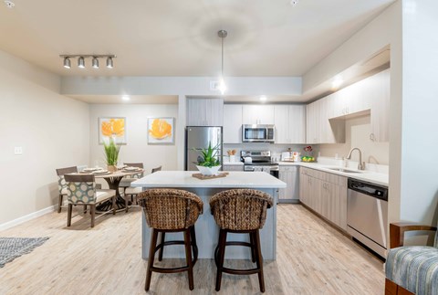 A kitchen with a table and chairs in the middle of the room.