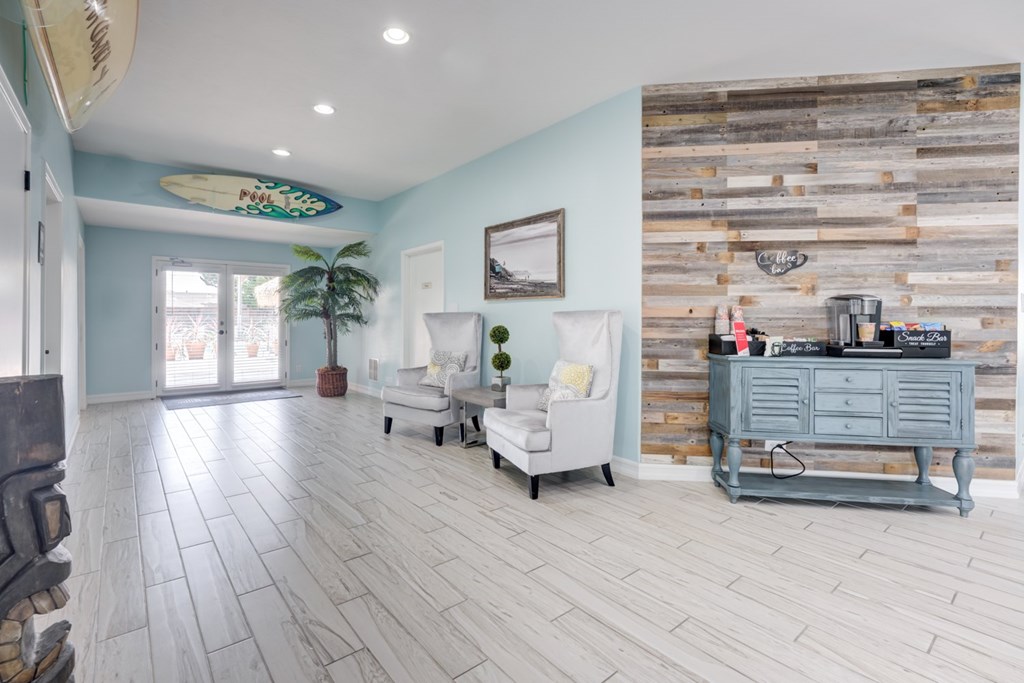 A living room with a white couch and a wooden wall.