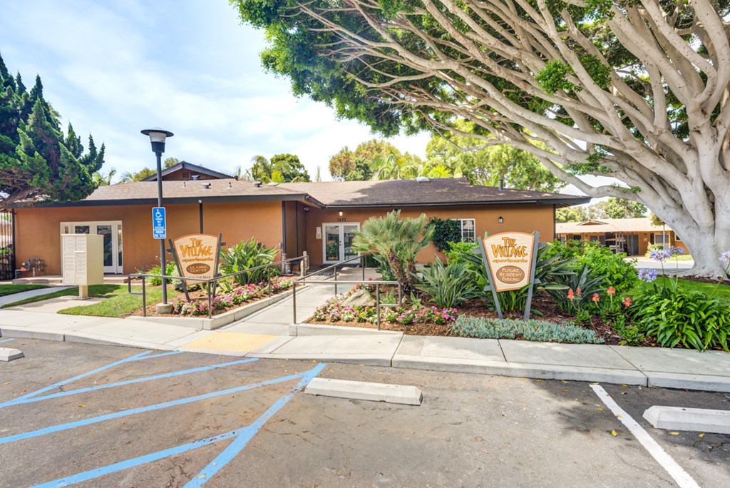 A building with a sign that says "Village" in front of it.