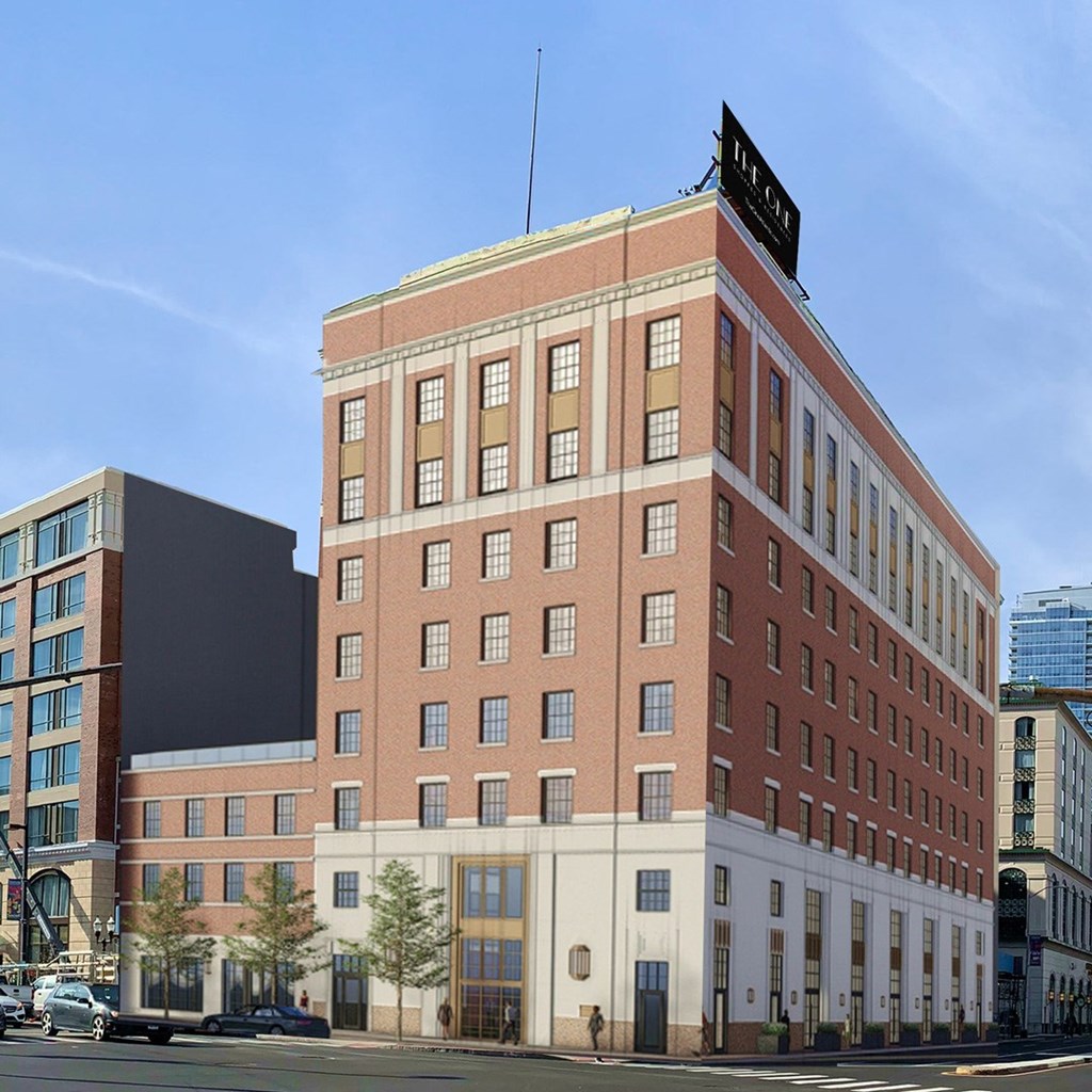 a tall brick building on the corner of a city street