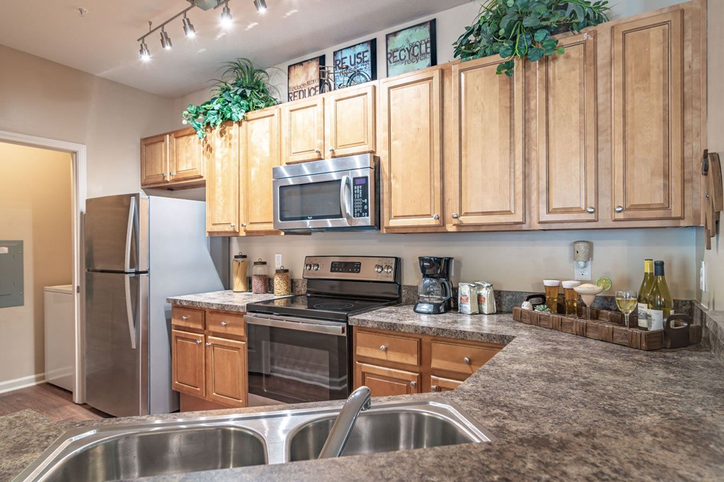 a kitchen with wooden cabinets and stainless steel appliances