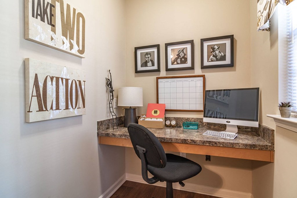 a home office with a desk and computer