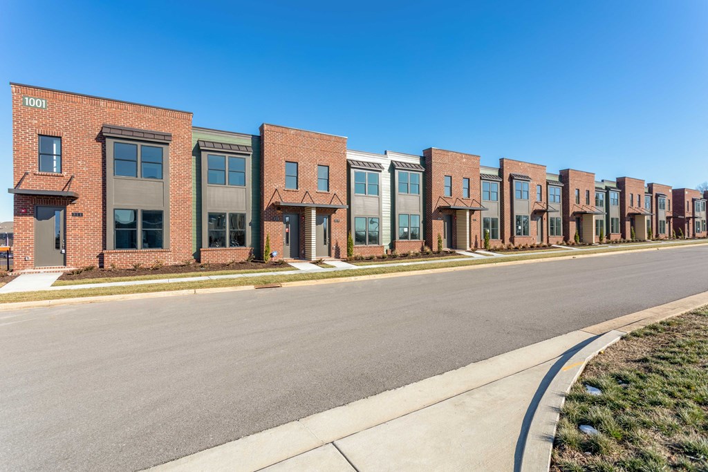 a row of brick apartment buildings on a street