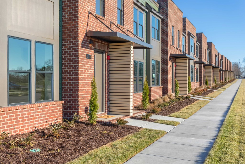 Townhomes for Rent in Gallatin, TN - The Gardens at Preston Park - Brick Building Exterior of Townhomes, with Path and Landscaped Grounds