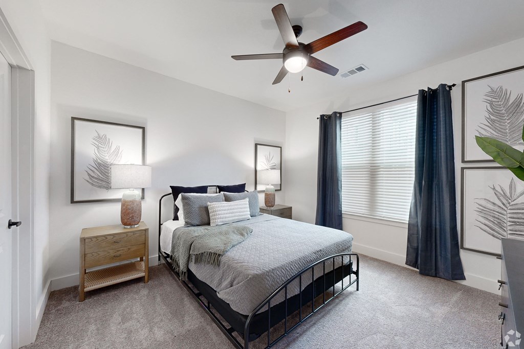 a bedroom with a bed and a ceiling fan