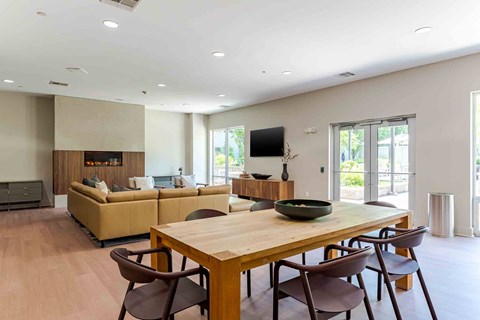 A modern dining room with a wooden table and chairs.