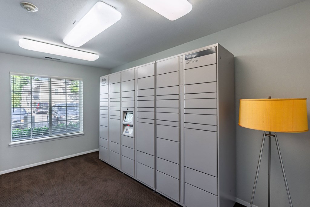 a large white closet in a room with a window and a lamp