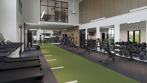 A gym with a variety of equipment including treadmills, weights, and exercise machines.