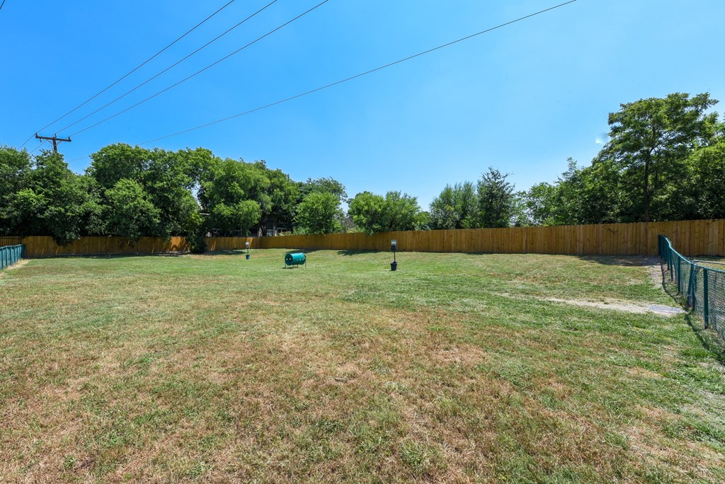 a backyard with a fenced in yard and a fence