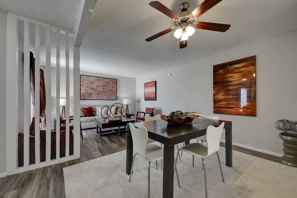 our living room and dining room with a table and chairs and a ceiling fan