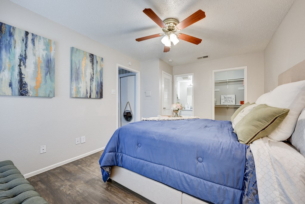 a bedroom with a bed and a ceiling fan