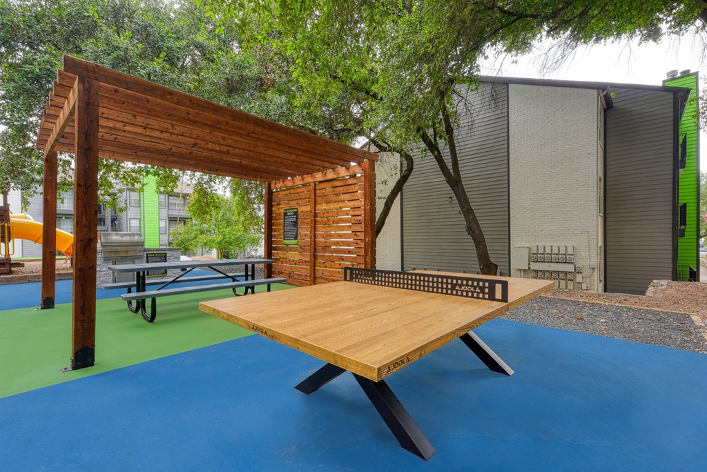 a ping pong table on a court in front of a building