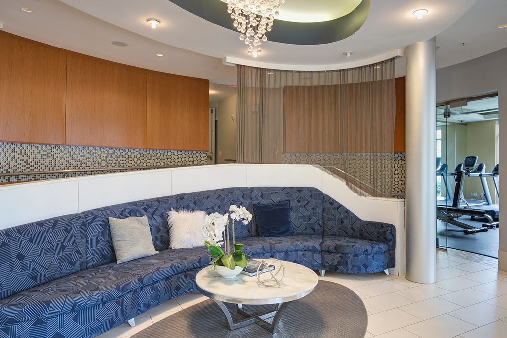 a living room with blue couches and a coffee table