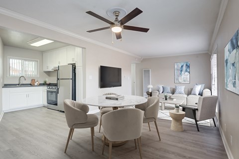 A modern dining room with a white table and chairs.