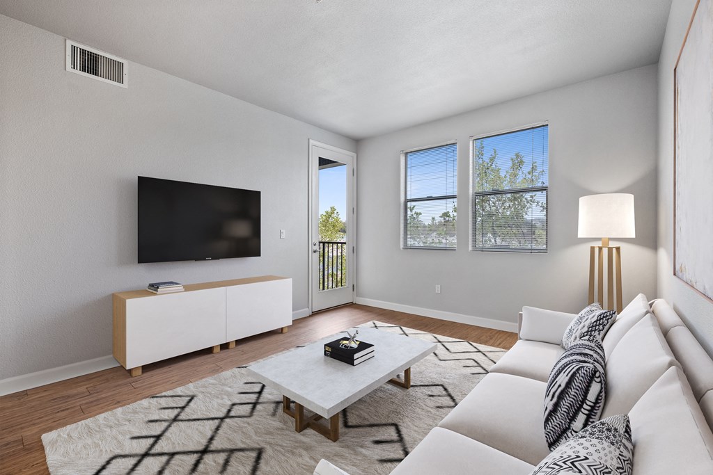 a living room with a white couch and a tv