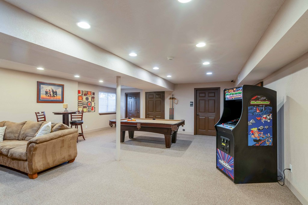a game room with a pool table and a jukebox
