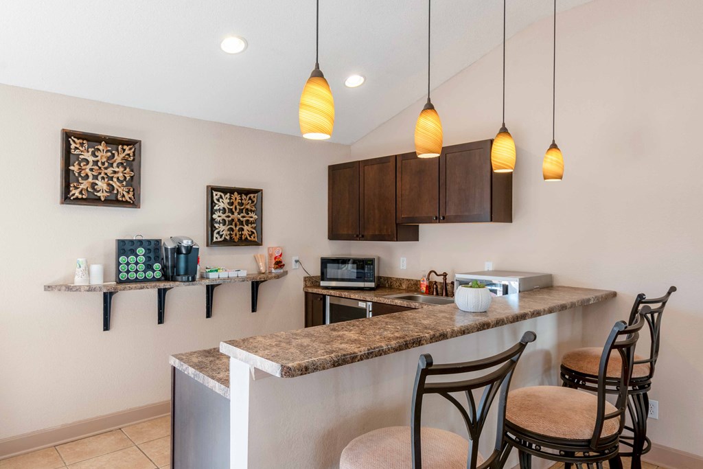 a kitchen with bar stools and a counter top with