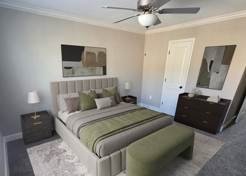 A bedroom with a large bed and a ceiling fan.