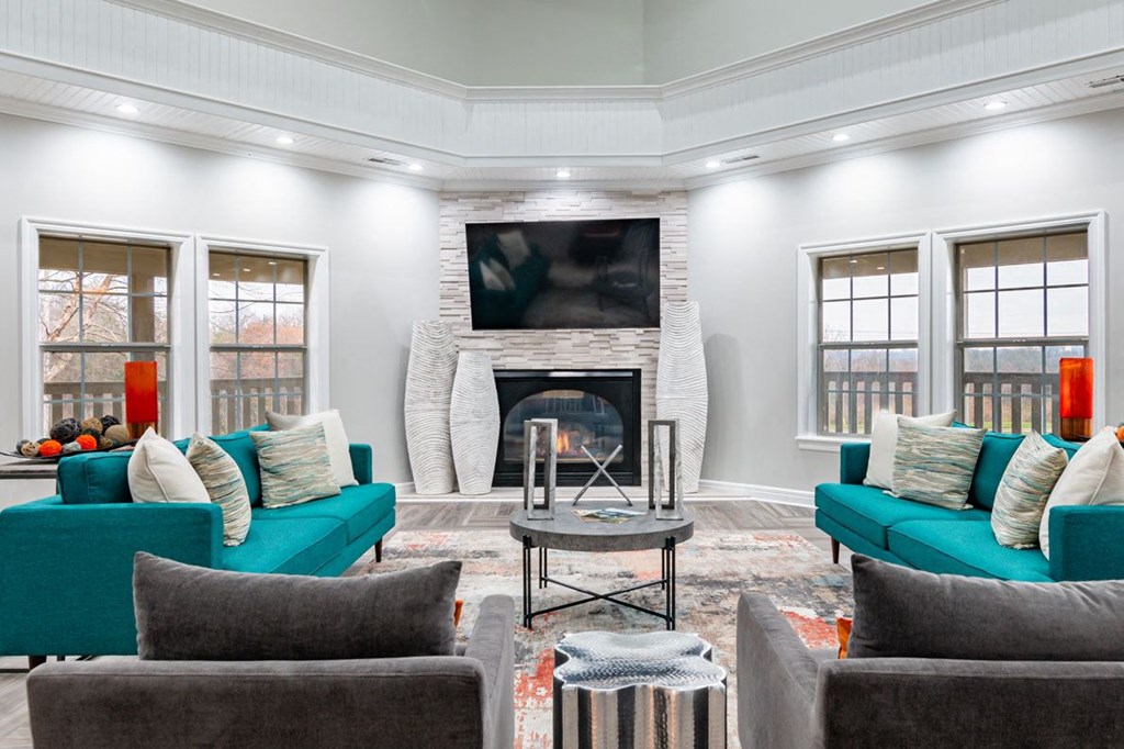 a living room with blue couches and a fireplace