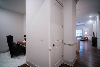 A hallway view connecting different living spaces, with a focus on clean lines and muted tones.