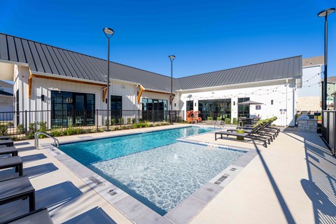 A pool area with a building in the background.