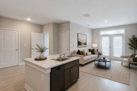 A modern kitchen with a large island and a living area with a couch and chairs.