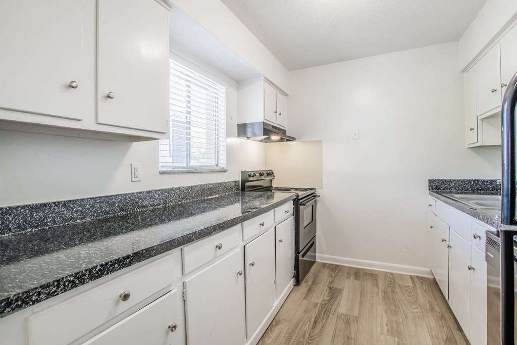 Kitchen with black appliances and lots of cabinets at Townsend Apartments in Jacksonville near Atlantic Beach, Florida.