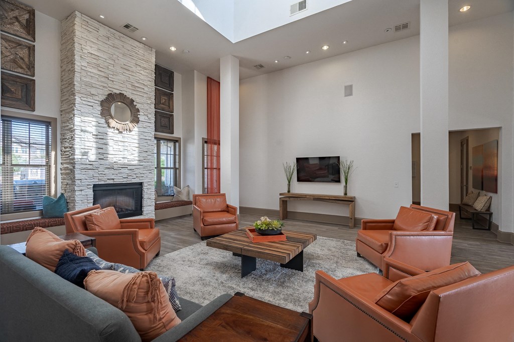 a living room with leather furniture and a fireplace