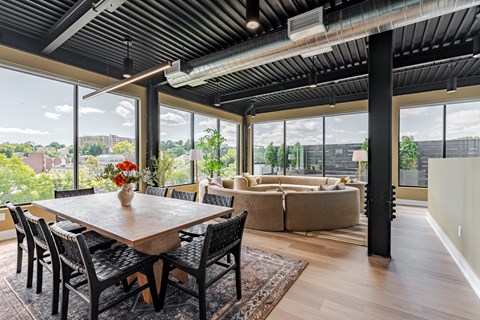 A dining room with a wooden table and chairs.
