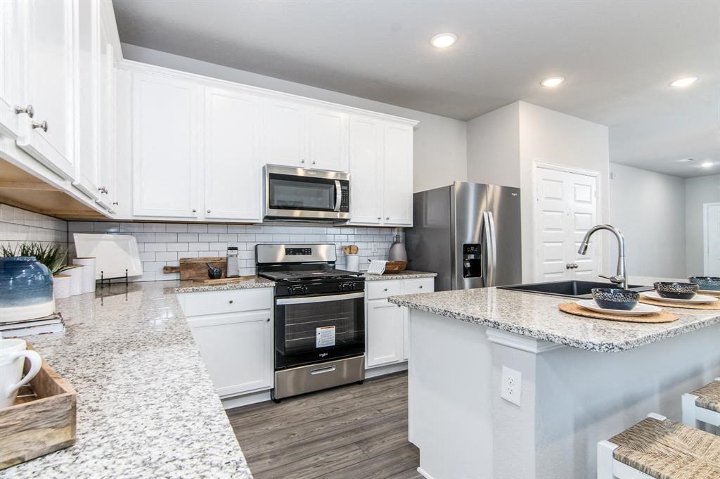 a kitchen with a stove top oven next to a sink