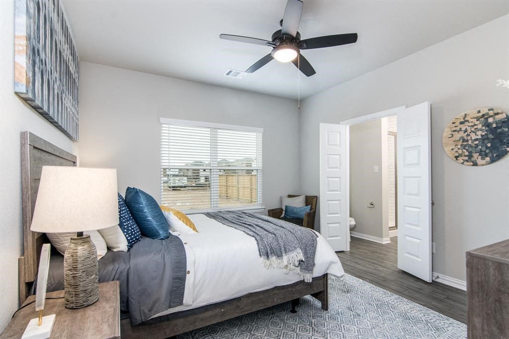 a bedroom with a bed and a ceiling fan