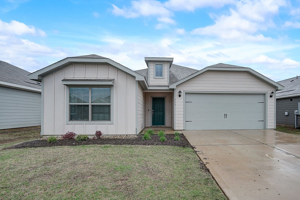 a white house with a driveway and a garage door