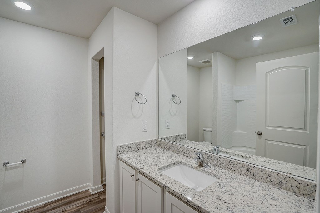 an empty bathroom with a sink and a mirror
