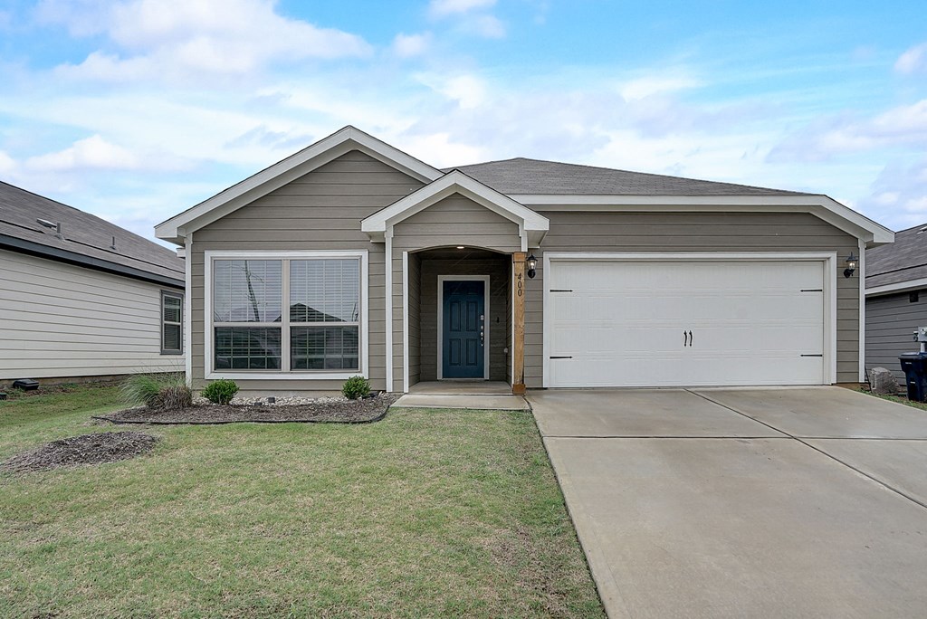 a brand new house with a driveway and a garage door
