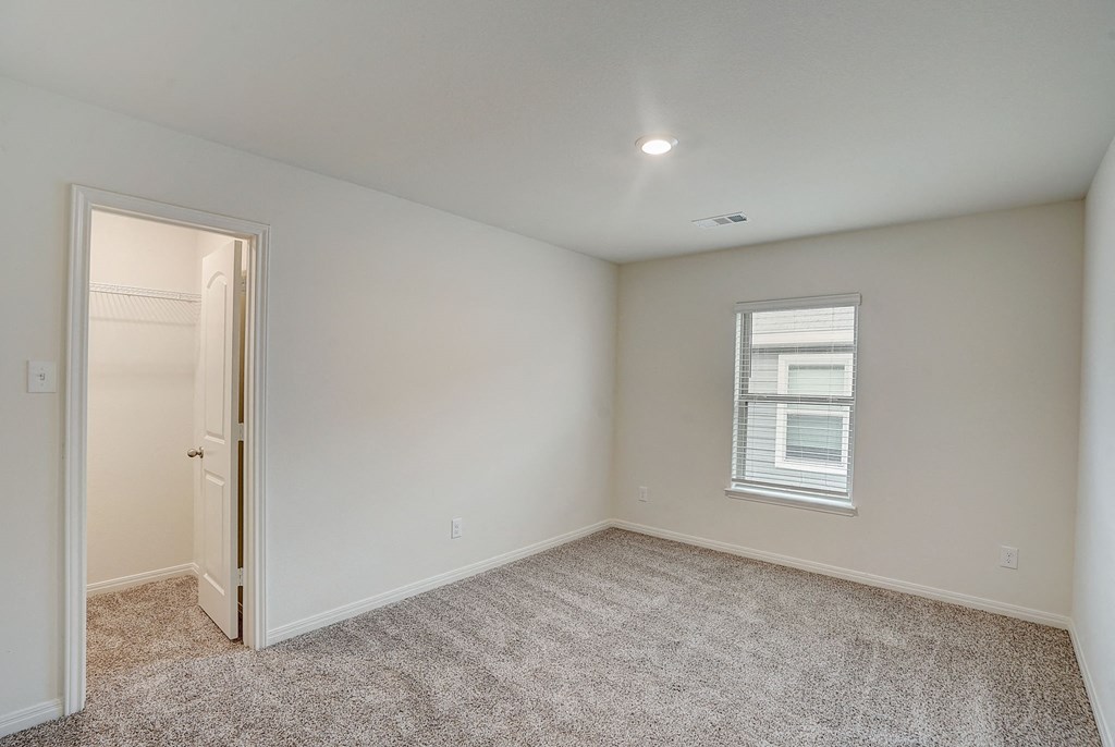 an empty room with a door and a window