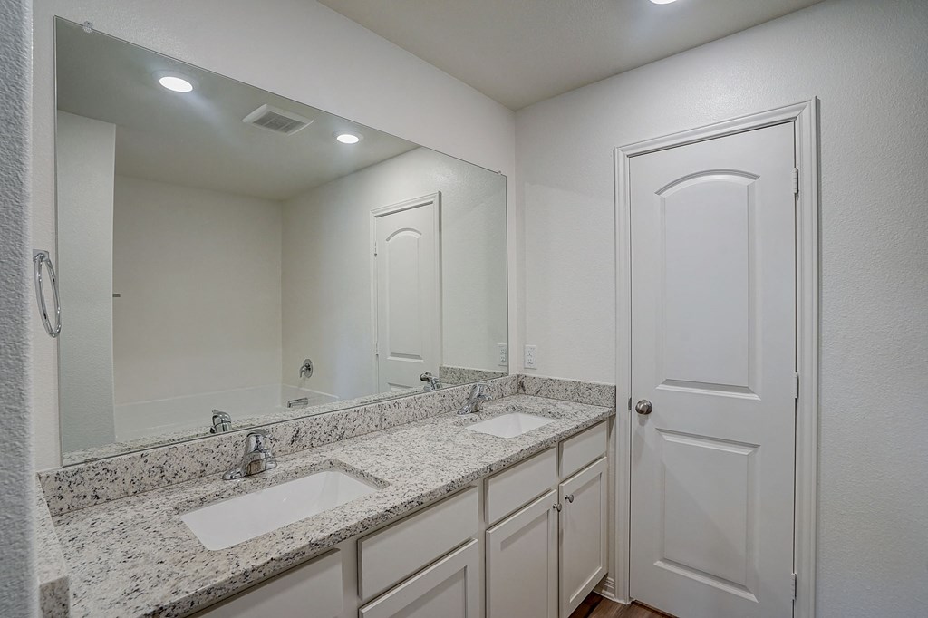 a bathroom with two sinks and a mirror