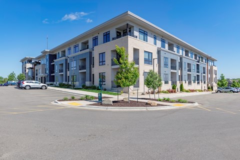 A large building with a parking lot in front of it.